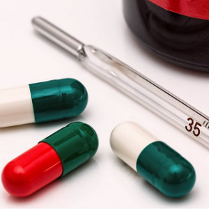 3 pills and thermometer
