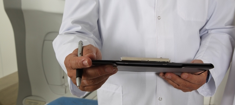 Doctor Holding Informed Consent Document