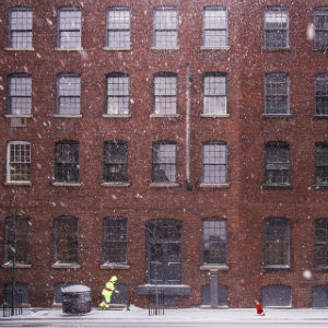 brick wall shoveling snow