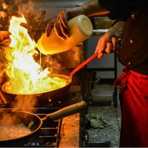 chef at stove with flame