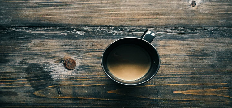 cup of coffee on wooden table