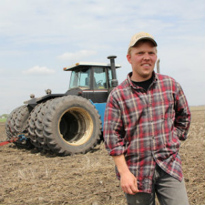 farmer standing in front of tractor
