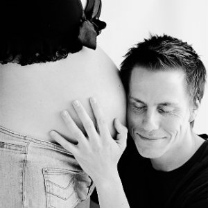 father listening to baby heartbeat