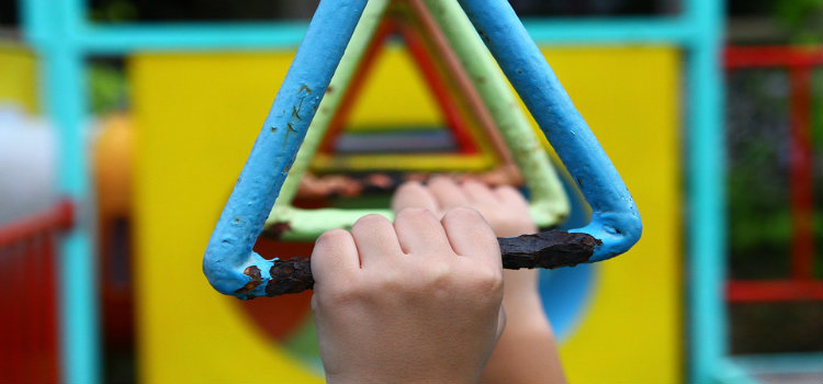 kids hands and jungle gym