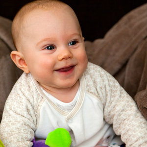 laughing baby with toy