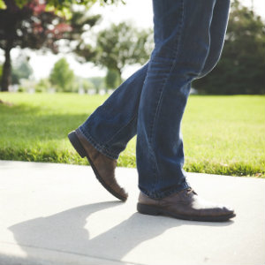legs walking on sidewalk