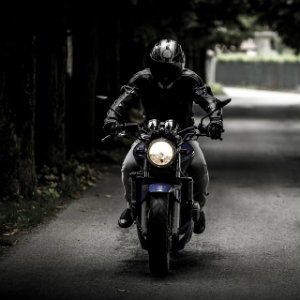 single biker riding down street