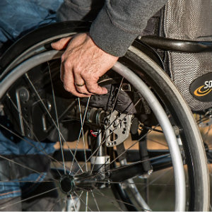 man's hand gripping wheelchair