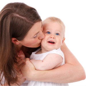 mom kissing baby's cheek