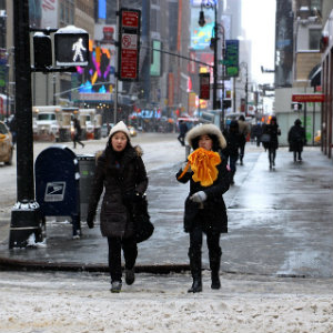 pedestrians snowy street in manhattan