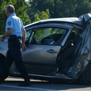 policelookingatdamagedcar