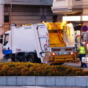 sanitation worker with garbage truck