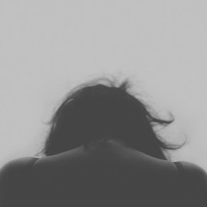 woman hunched over back and shoulders